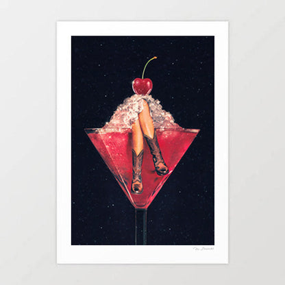 Cherry Cowgirl Margarita surreal art print — two tanned legs wearing brown leather cowboy boots sticking up from crushed ice inside a deep crimson red martini cocktail glass topped with a glossy maraschino cherry, against a deep black starry night sky background, cowgirl core western bar art for bachelorette parties Nashville lovers and coquette interiors