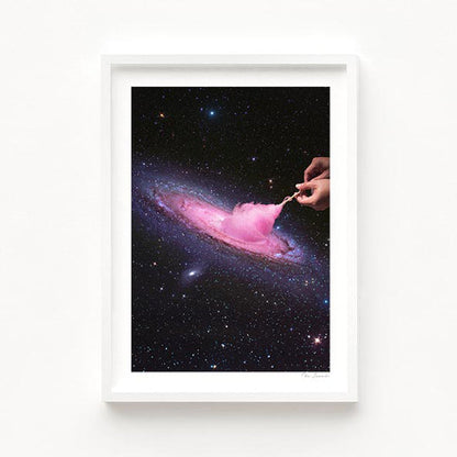 Surreal art print — hand pulling the Andromeda galaxy apart like pink cotton candy against a deep starry night sky, cosmic fairground space wall art by Vertigo Artography