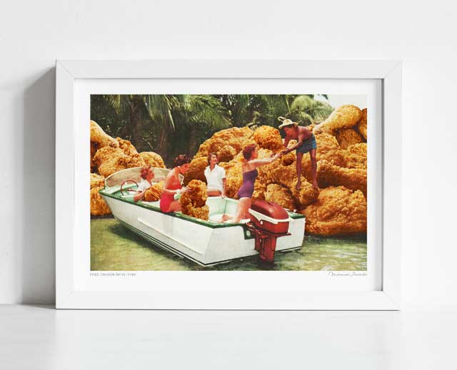 Fried Chicken Drive-Thru art print framed horizontal — surreal vintage collage of a 1960s leisure boat passing through a tropical channel flanked by enormous golden fried chicken boulder cliffs as a man passes a piece of chicken down to a woman in a purple swimsuit, kitsch tropical food art for home bars coastal homes and gallery walls