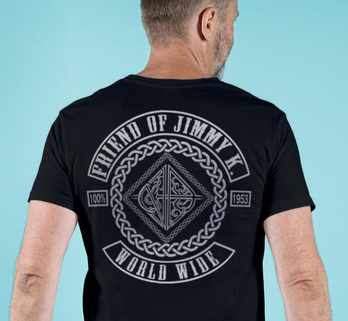 Man wearing a black t-shirt with a graphic design on the back against a light blue background