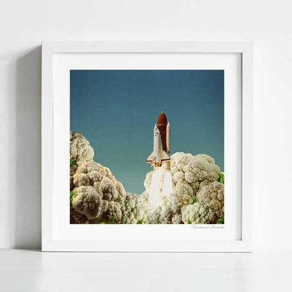 Houston We Have Cauliflower art print framed view — surreal retro collage of rocket ship and cauliflower launch pad, quirky space food humour wall art for dining rooms and man caves