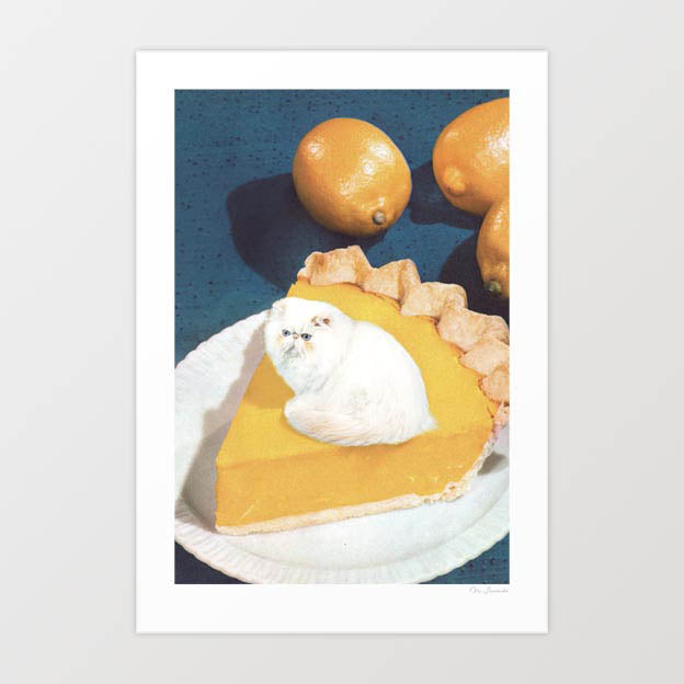 Lemon Meow Pie surreal art print — tiny fluffy white Persian cat sitting on top of a golden lemon meringue pie slice on a white plate, the white cat perfectly substituting for the meringue topping, deep amber lemon curd filling with crimped pastry crust, two whole lemons on a dark teal vintage blue background, retro food and cat art for kitchens, cat cafes and cat lover interiors