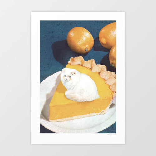 Lemon Meow Pie surreal art print — tiny fluffy white Persian cat sitting on top of a golden lemon meringue pie slice on a white plate, the white cat perfectly substituting for the meringue topping, deep amber lemon curd filling with crimped pastry crust, two whole lemons on a dark teal vintage blue background, retro food and cat art for kitchens, cat cafes and cat lover interiors