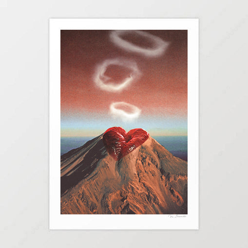 Rings of Passion art print — glossy red lips pursed at the peak of a volcanic mountain blowing three white smoke rings into a warm terracotta and blush dusk sky, surreal romantic landscape wall art for bedrooms and eclectic interiors